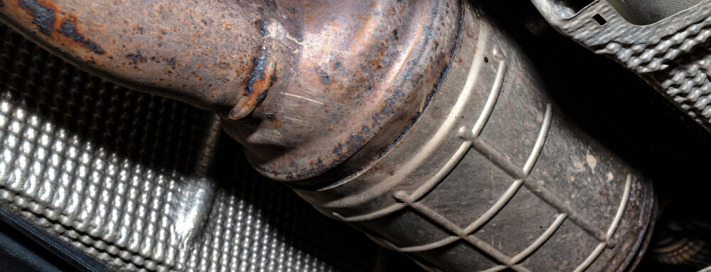 Close up photo of catalytic  car converter from a car.
